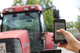 Smartpone in front of a tractor