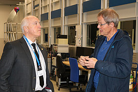 ASABE President Keith G. Tinsey talking with Thomas Amon in front of ATB's wind tunnel. (Photo: ATB)