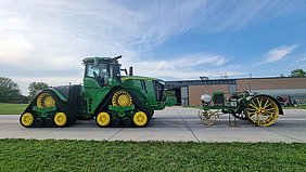 Today's tractor next to one from 100 years ago