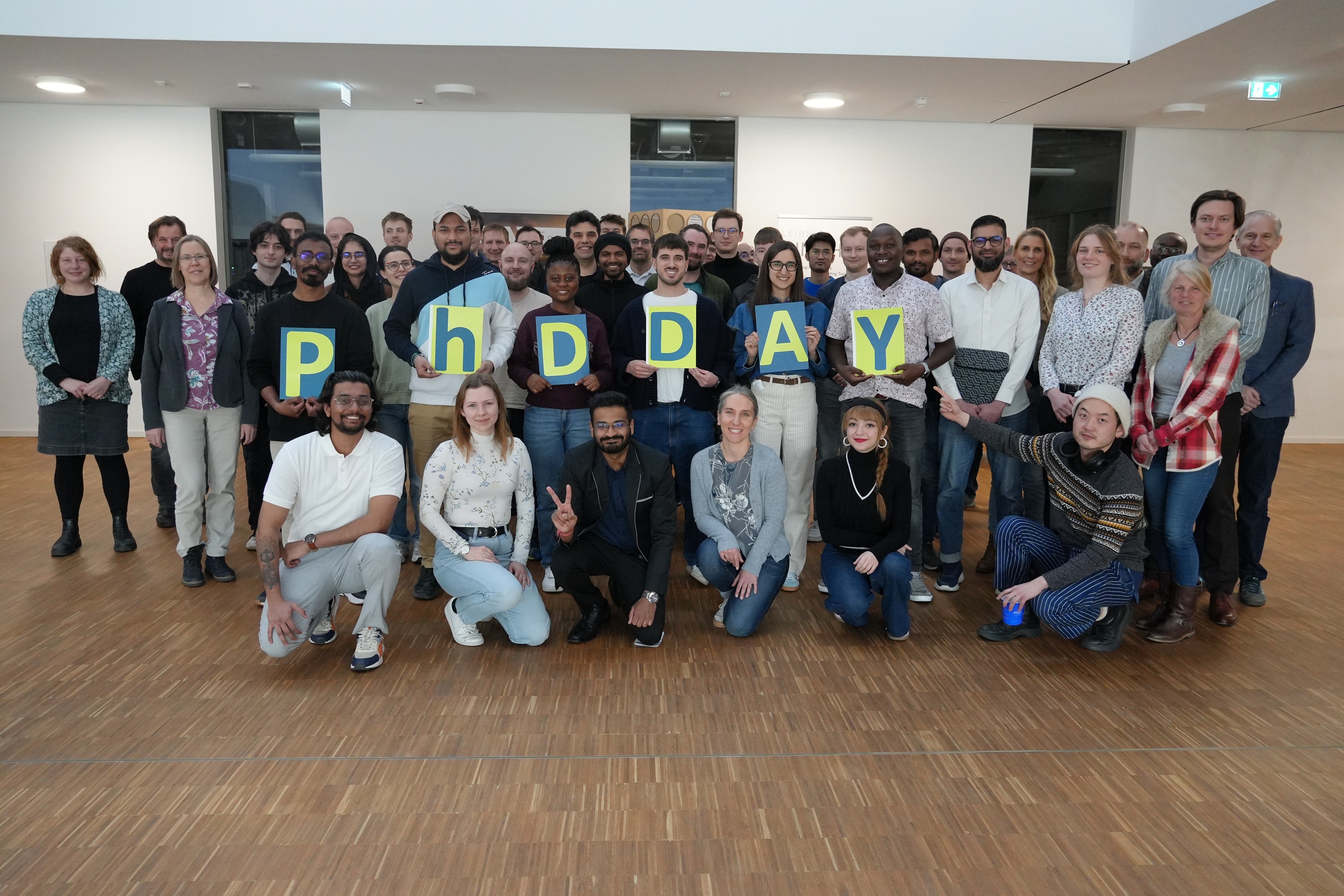 Group photo of the participants holding letters spelling out "PHDDAY".